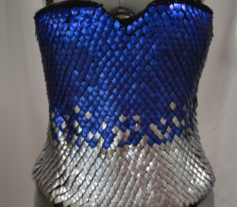 A blue and silver knitted dragonhide tube top with spaghetti straps.