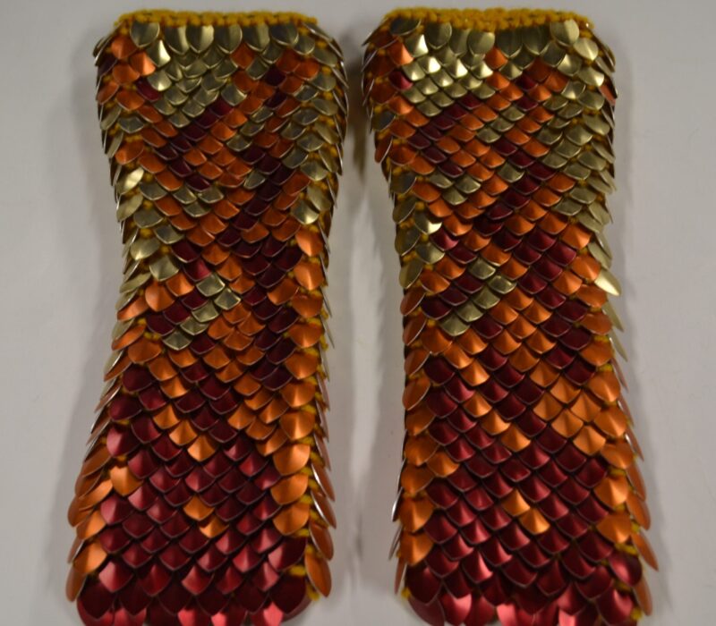 Red, orange, and gold long gauntlets with gold yarn