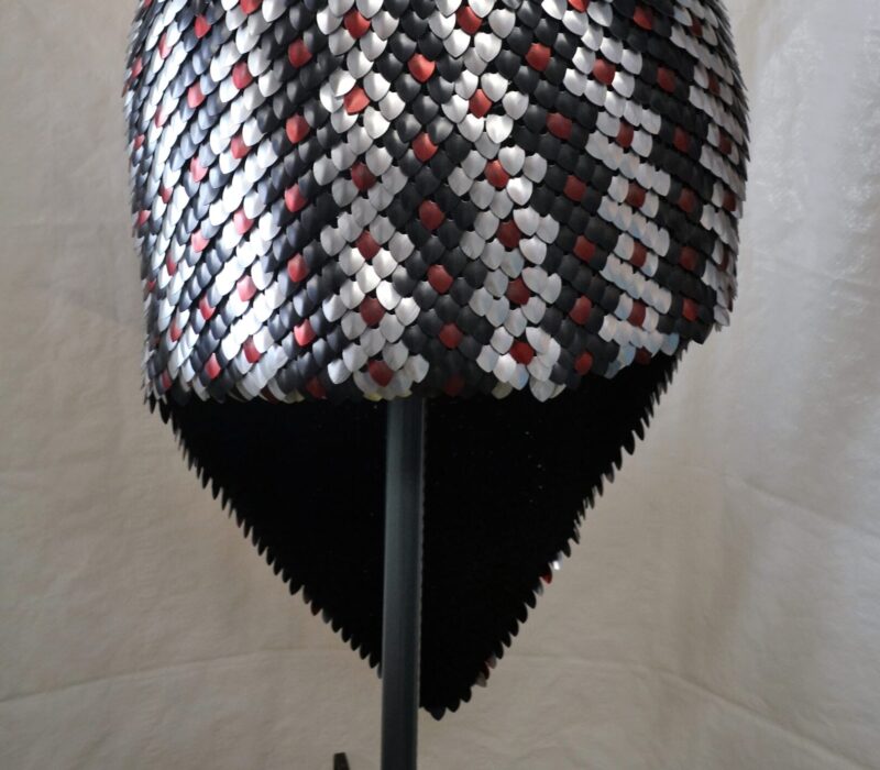 A knitted scalemaille skirt with a snakeskin pattern modelled on a dress form
